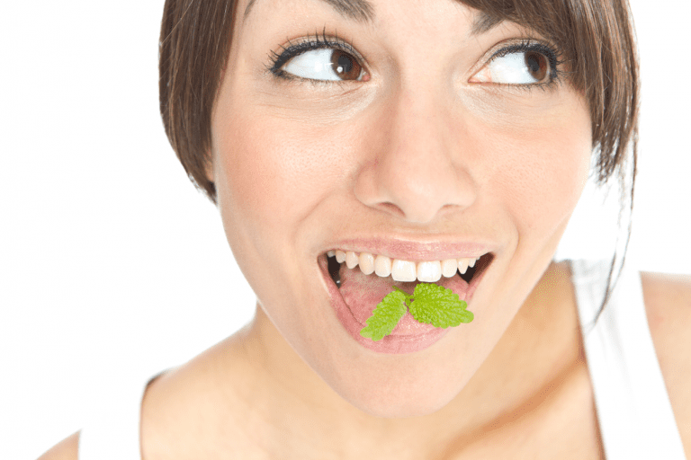 Image of a person with a mint in their mouth.